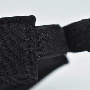 Macro detail of black cotton sun hat featuring adjustable velcro strap and reinforced stitching