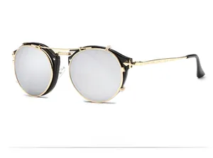 Macro view of steampunk flip-up sunglasses with gold metal frame and detailed engraving