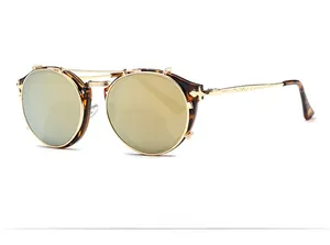 Close-up of retro round tortoiseshell sunglasses with gold metal bridge and engraved temples