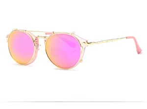 Detailed 45-degree macro of steampunk gold metal frame sunglasses with pink mirrored lenses