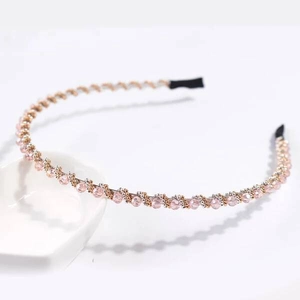 Close-up of pink beaded crystal headband with metallic woven details and anti-slip tips