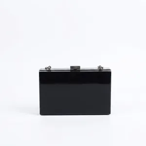 Modern black acrylic clutch bag with shiny mirror finish and silver snake chain strap