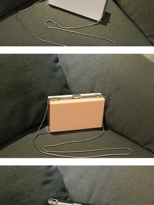 Detailed view of acrylic clutch bags in white, pink, and black with metal chains