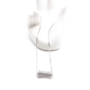 Silver necklace with micro-paved zircon cylinder pendant on a hand-shaped display stand