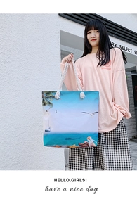 Detail of nautical print on canvas beach tote with white braided cotton rope handles