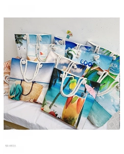 Detailed view of canvas beach tote bags with summer prints and cotton rope handles