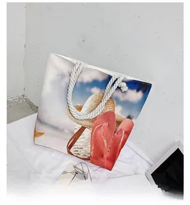 Detail of canvas beach tote featuring thick cotton rope handles and seaside theme print