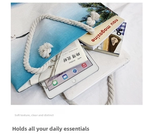 Top view of a large canvas beach tote with sea print and rope handles for travel