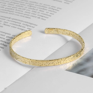 Minimalist S925 golden open bangle featuring hand-hammered texture and star engraving
