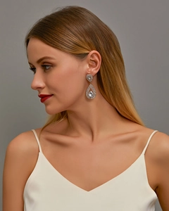 Close-up of elegant double teardrop crystal earrings with shimmering silver metal base
