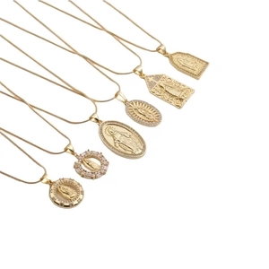 Seven gold plated Virgin Mary pendant necklaces with cubic zirconia in various shapes