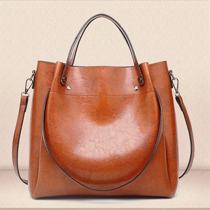 Classic brown oiled leather bucket bag with large capacity and dual-use shoulder strap