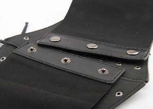Close-up of black elastic waist belt featuring metal snap buttons and eyelet textures
