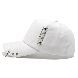 Close-up of white cotton baseball cap featuring silver metal rings and X-shaped buckles