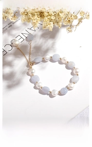 Detailed shot of amethyst and freshwater pearl bracelet with adjustable gold chain link
