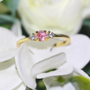 Elegant gold-plated wedding ring featuring a pink round zircon center stone and side accents