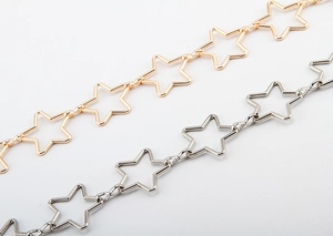 Detailed close-up of gold and silver star-shaped metal link chains on white background