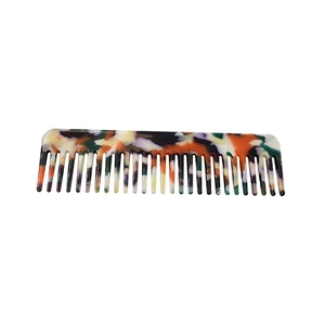 Minimalist leopard print acetate hair comb with tortoiseshell pattern on white background