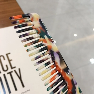 Elegant tortoiseshell acetate hair comb with colorful marble patterns for women