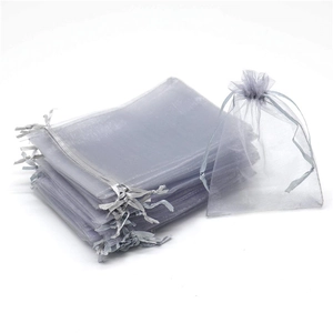 Macro detail of grey organza pouches with gold coral print and drawstring closure
