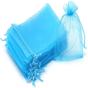 Detail of sky blue organza gift bags with gold coral patterns and drawstring closure
