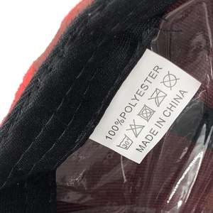 Detail shot of the 100% polyester fabric label with care instructions on baseball cap
