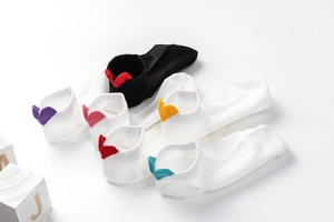 Detail of cotton ankle socks featuring colorful heart-shaped heel tabs in various colors