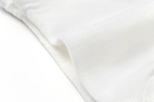 Detailed macro view of white ribbed knit fabric texture and soft elastic weaving