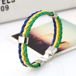 Detail of braided PU leather bracelet in vibrant Brazil flag colors with metal clasp