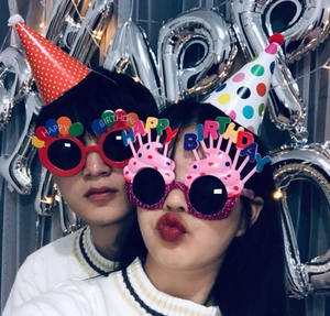 Selfie view of funny daisy birthday glasses and party hats for photo booth props