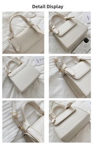 Close-up of white crocodile pattern texture and gold-tone hardware on handbag