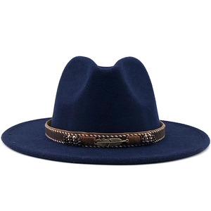 Detail of dark blue wool fedora with brown braided band and golden feather ornament