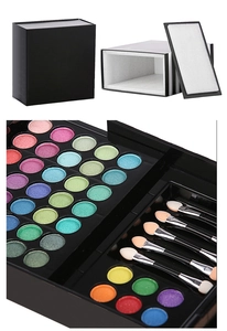 Macro view of 177-color professional makeup palette with eyeshadows and brushes
