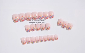 Close-up of candy color polka dot French press-on nails with multi-color tip accents