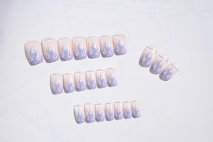 Detail of light blue flame press-on nails set with 24 pieces on white paper background
