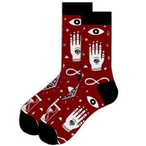 Detail of occult themed crew socks with mystical illustrations on deep red fabric