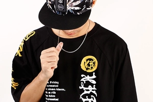 Close-up of a silver thick chain link necklace worn by a male model for hip-hop style