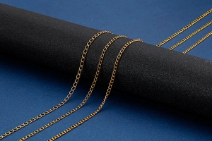 Close-up of golden stainless steel flat cable chains in various thicknesses for DIY jewelry
