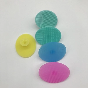 Detail showing colorful oval silicone facial cleansers with soft bristles and suction cups