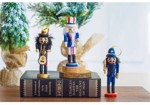 Close-up of colorful wooden nutcracker soldier ornaments hanging with festive background