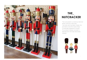 Detail view of large nutcracker soldier ornaments in a festive store showroom display