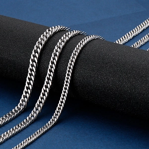 Silver cuban link chain for men in stainless steel wrapped around a black display stand
