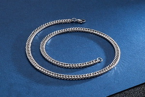 Detailed view of silver stainless steel Cuban link chain with lobster clasp and metal texture