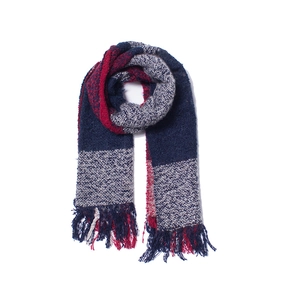 Close-up of red and blue plaid knit scarf featuring soft yarn texture and fringe tassels