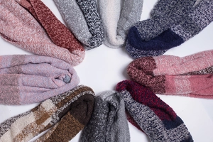 Flat lay of colorful knit blend socks with stripes and plaid patterns on white