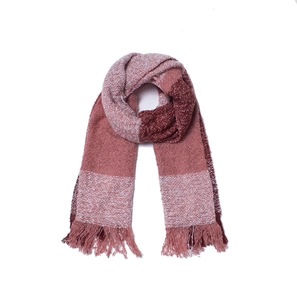 Close-up of pink and maroon knit scarf texture featuring soft tassel fringe details