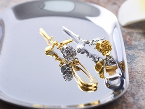 Polished titanium steel rose and safety pin dangle earrings in gold and silver finish