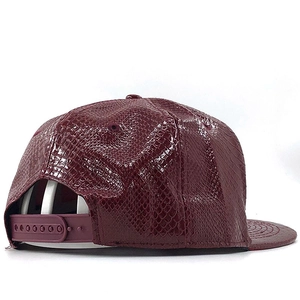Dark burgundy snapback cap with faux crocodile texture and adjustable back strap