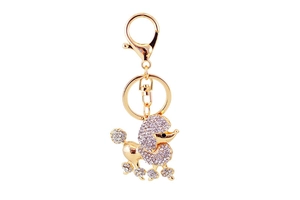 Close-up of golden poodle keychain featuring sparkling crystals and a lobster clasp