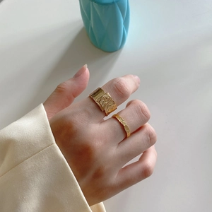 Minimalist gold S925 sterling silver ring set with irregular hammered texture on model hand